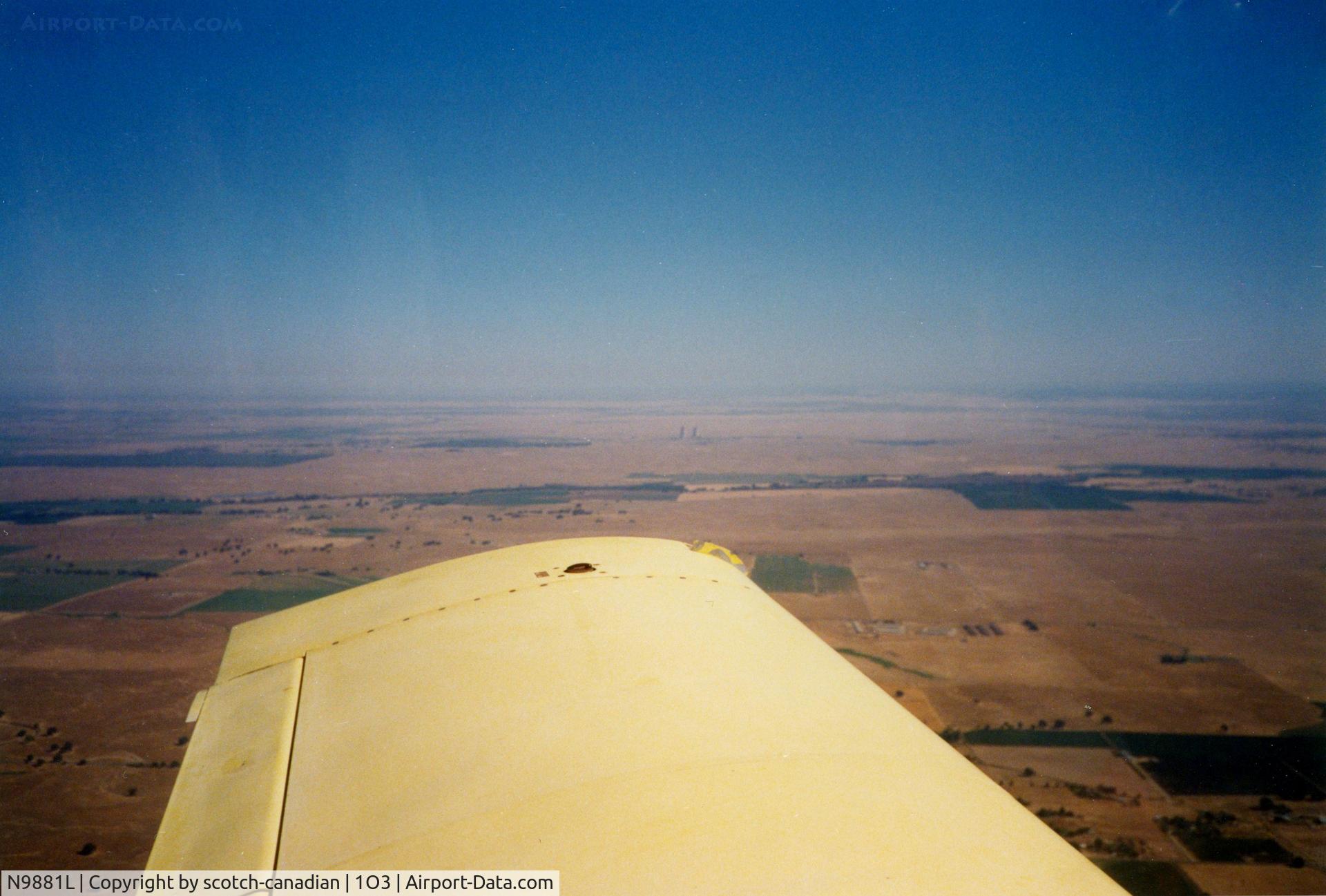 N9881L, 1974 Grumman American AA-1B Trainer C/N AA1B-0481, 1974 Grumman American Avn. Corp. AA-1B N9881L in flight near Clements, CA - Rancho Seco Cooling Towers can be seen in the distance.