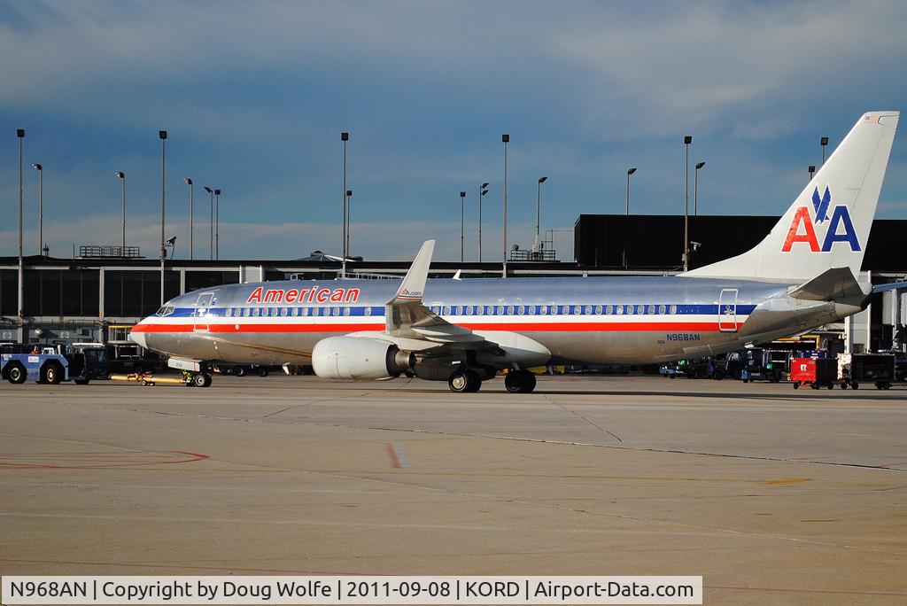 N968AN, 2001 Boeing 737-823 C/N 30095, Tug pulls outbound AA jet from gate at Chicago O'Hare.
