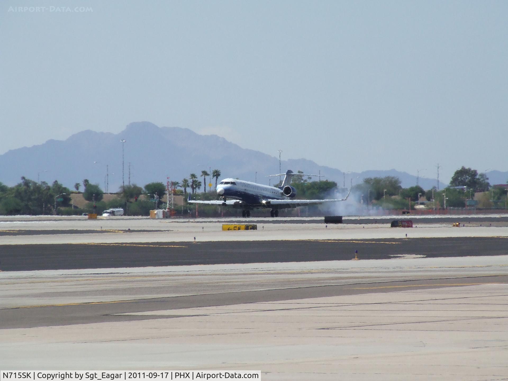 N715SK, 2004 Bombardier CRJ-700 (CL-600-2C10) Regional Jet C/N 10179, A little tire smoke
