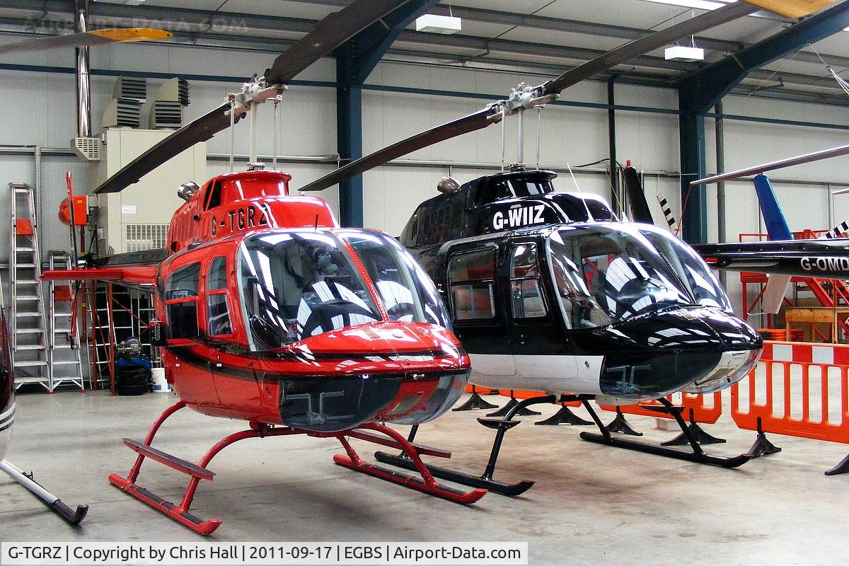 G-TGRZ, 1977 Bell 206B JetRanger II C/N 2288, alongside G-WIIZ inside the Tiger Helicopter hangar