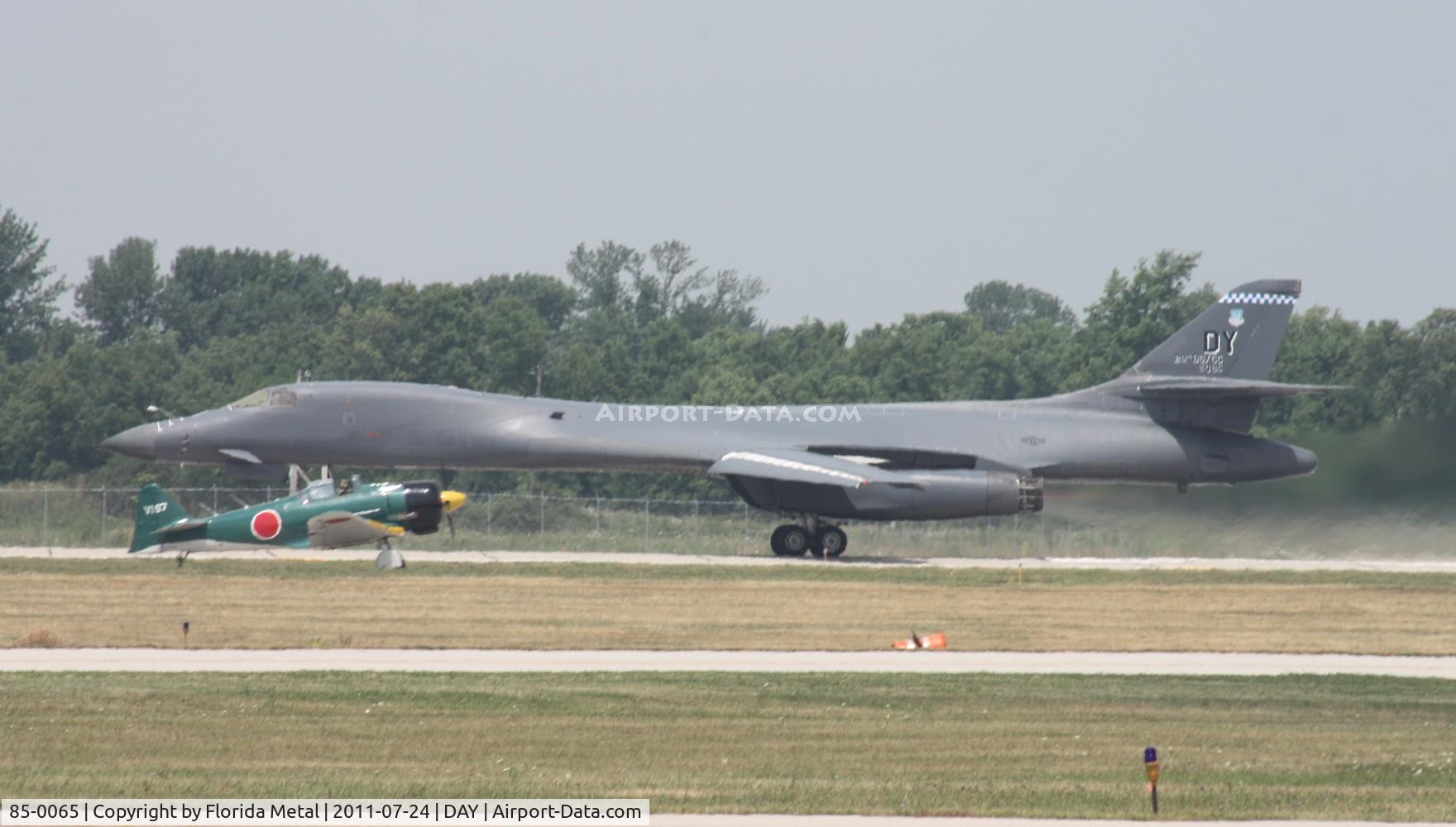 85-0065, 1985 Rockwell B-1B Lancer C/N 25, B-1 taking off with Tora Tora Tora planes taxiing in