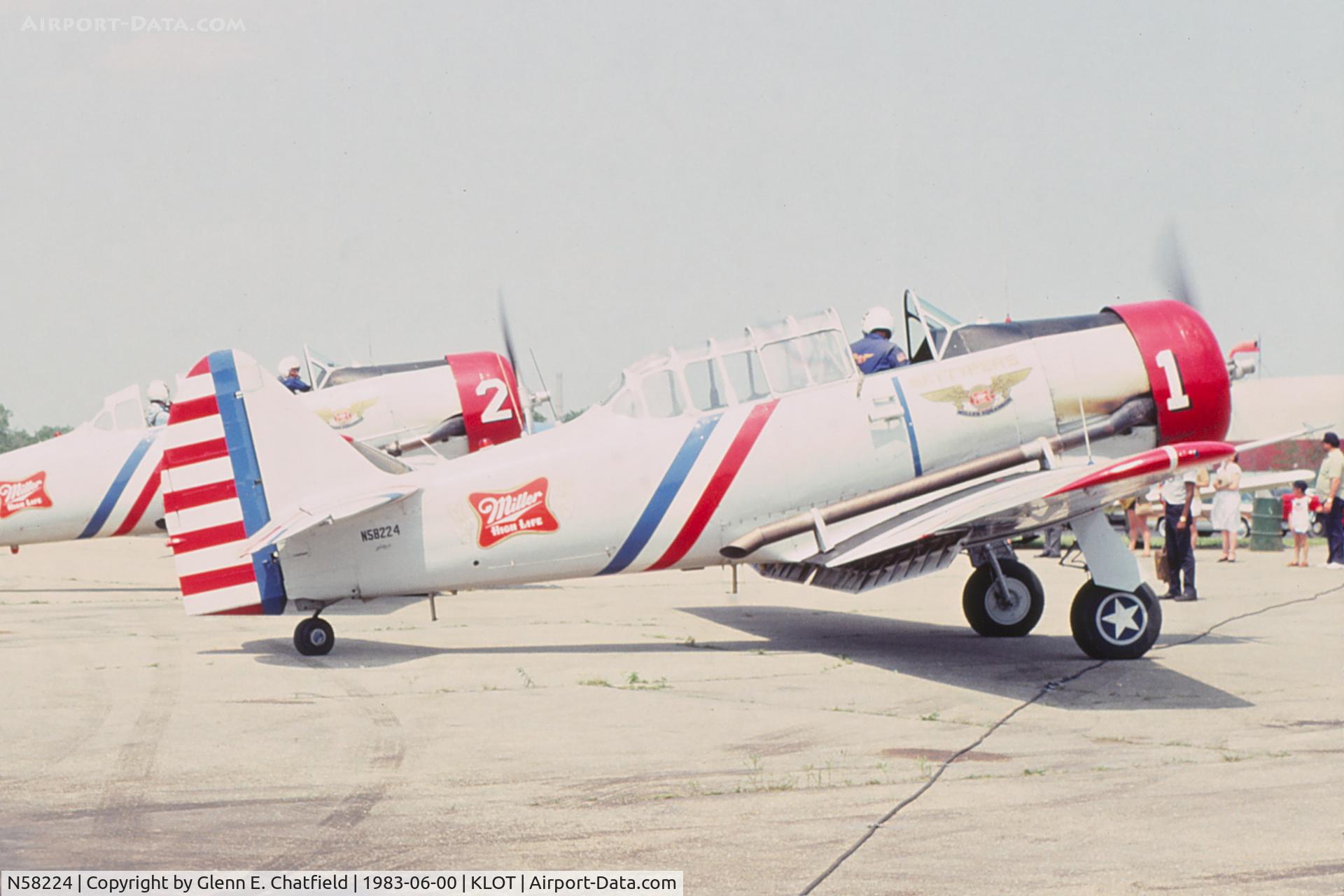 N58224, 1941 North American AT-6B Texan C/N 2553, SNJ-2 BuNo 2553.  Group has just landed after a demonstration.