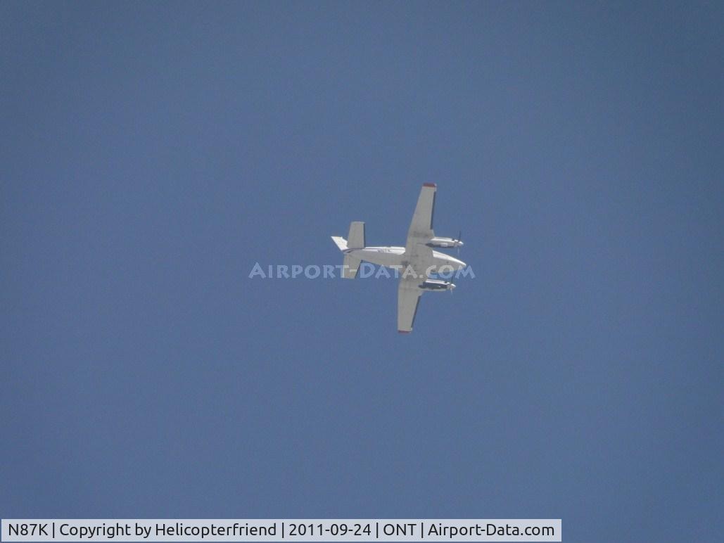 N87K, 1964 Beech S35 Bonanza C/N D-7607, At or above 2500 feet with permission to cross the airport heading south