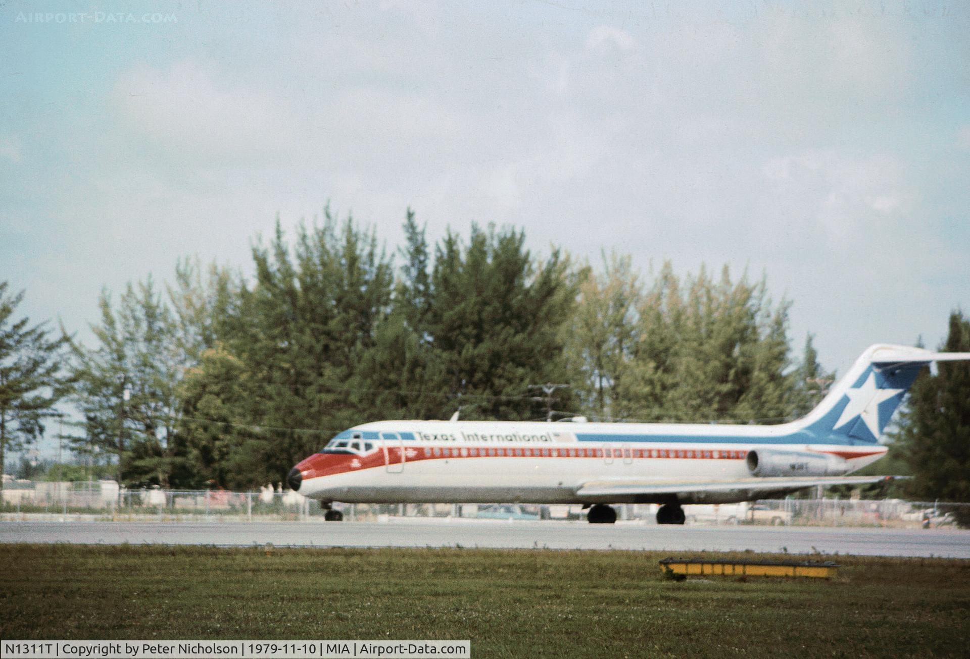 N1311T, 1969 Douglas DC-9-31 C/N 47490, Texas International DC-9-31 taxying at Miami in November 1979.