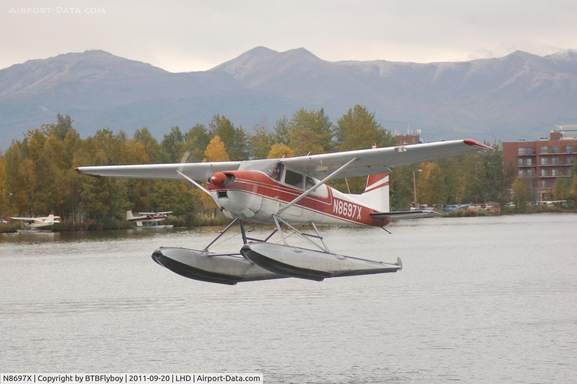 N8697X, 1962 Cessna 180E C/N 18051097, Departing from the Lake Spenard end of the Lake Hood Seaplane base Anchorage, AK