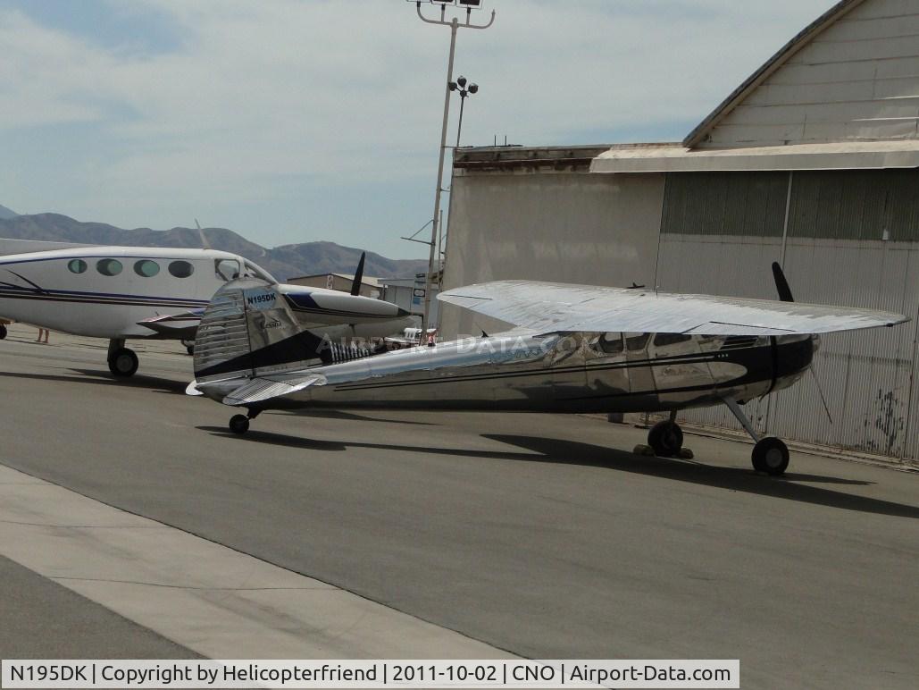 N195DK, 1950 Cessna 195A C/N 7615, Parked by a hanger