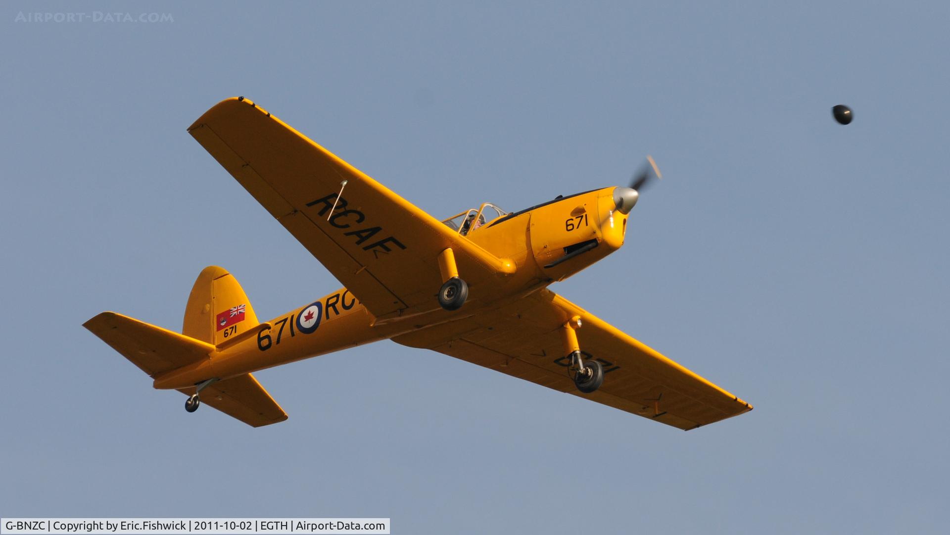 G-BNZC, 1952 De Havilland DHC-1 Chipmunk 22 C/N C1/0778, 5. G-BNZC about to nail a ballon at  Shuttleworth Autumn Air Display, October, 2011