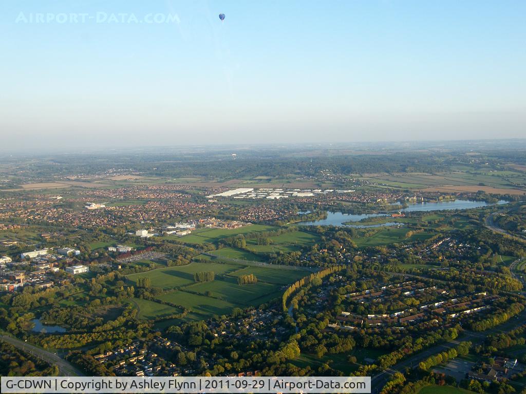 G-CDWN, 2006 UltraMagic N-210 C/N 210/33, Taken from G-AWFZ when flying inbound to Cranfield. The SKY hotair balloon is a regular sight around Milton Keynes and this was the second evening in a row I caught it inflight. Floating over Caldecotte lake, Milton Keynes.