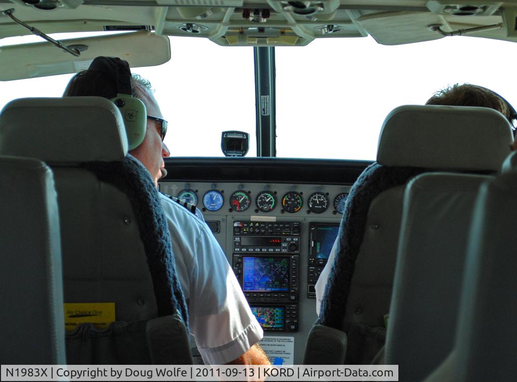 N1983X, 2003 Cessna 208B Grand Caravan C/N 208B1013, View of pilot from cabin while taxing at Chicago O'Hare for flight to Decatur, Illinois.  Air Choice One.