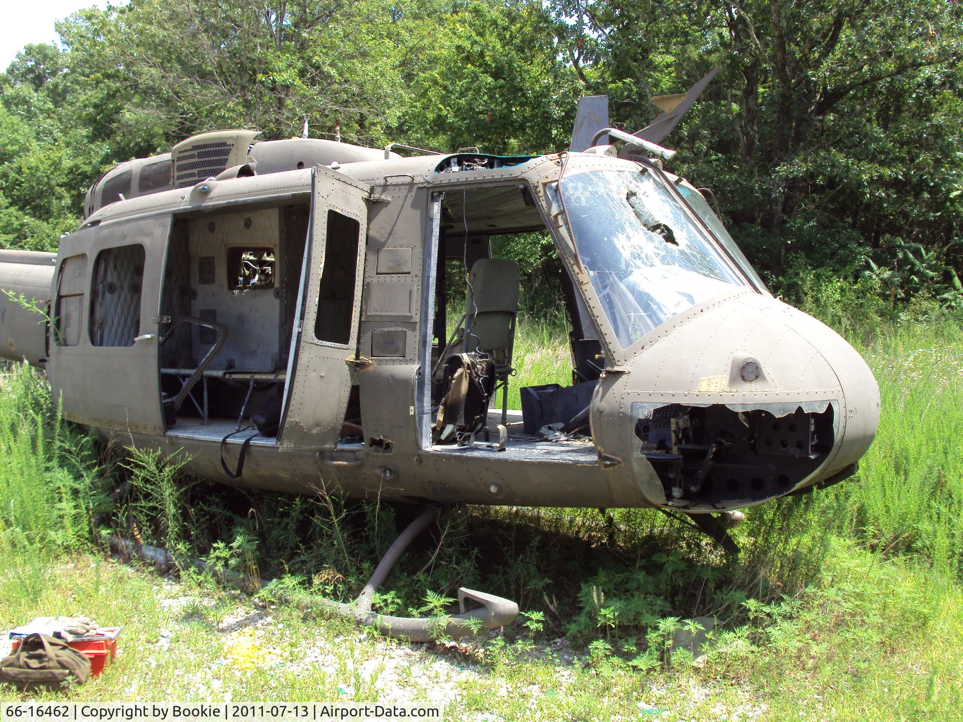 66-16462, 1966 Bell UH-1H Iroquois C/N 8656, Here's a closer shot.  Can you make out the patched bullet hole on the nose, over the chin bubble?  The hot Missouri sun has really faded her paint job.  Ft. Leonard Wood