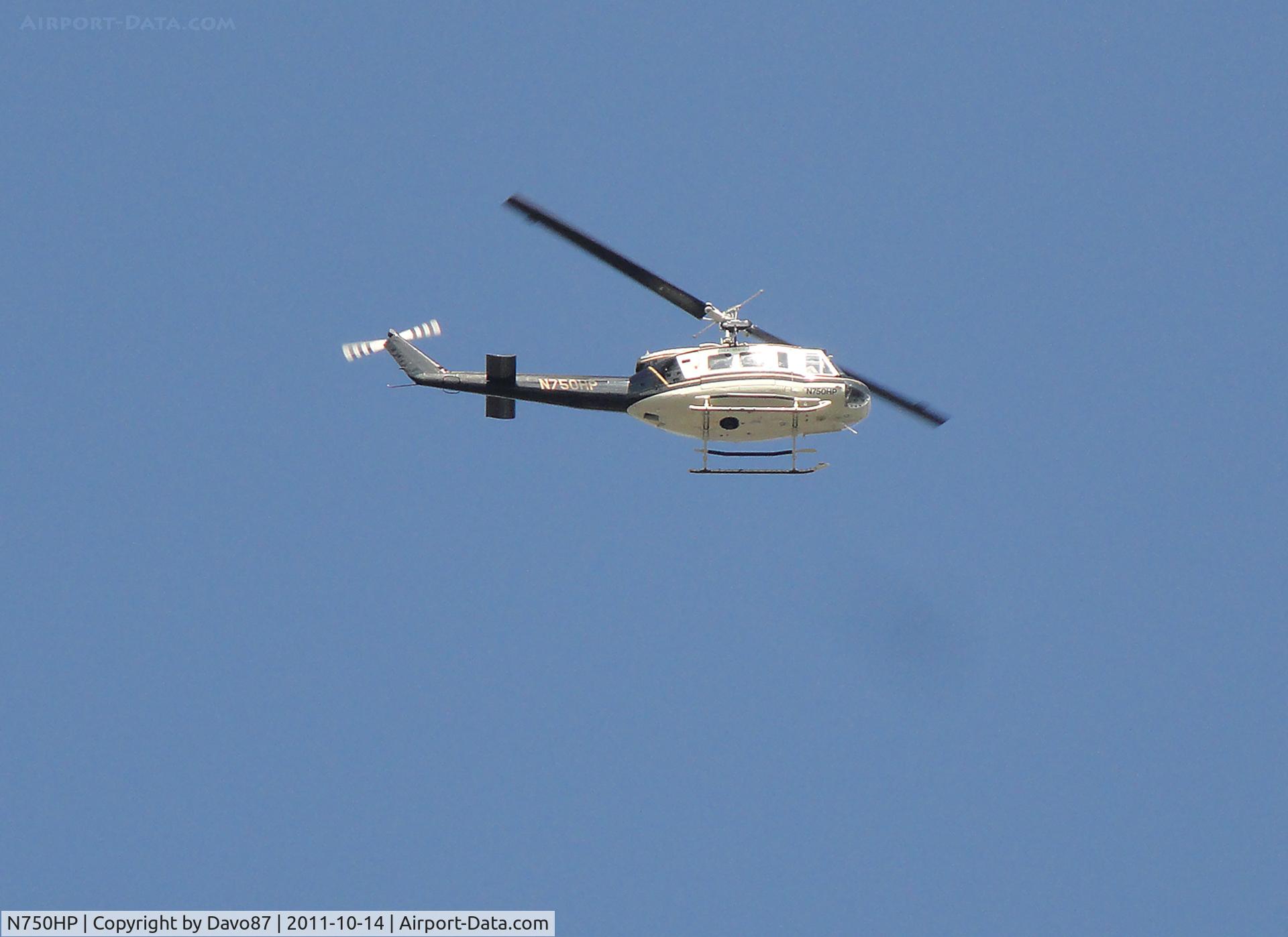N750HP, 1970 Bell UH-1H C/N 70-16409, Huey flying over Bristol Motor Speedway on Friday, October 14, 2011.