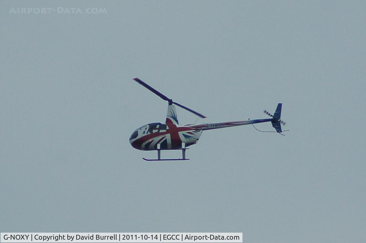G-NOXY, 2004 Robinson R44 Raven C/N 1421, Robinson R44 Raven over Manchester Airport.