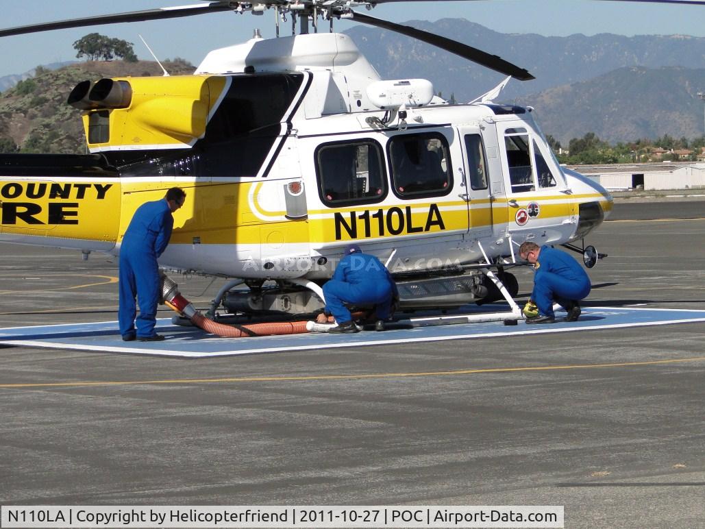 N110LA, 2005 Bell 412EP C/N 36392, After re-fueling, Crew assembles the Kawak Industries auxiliary hydraulic power system  snorkel