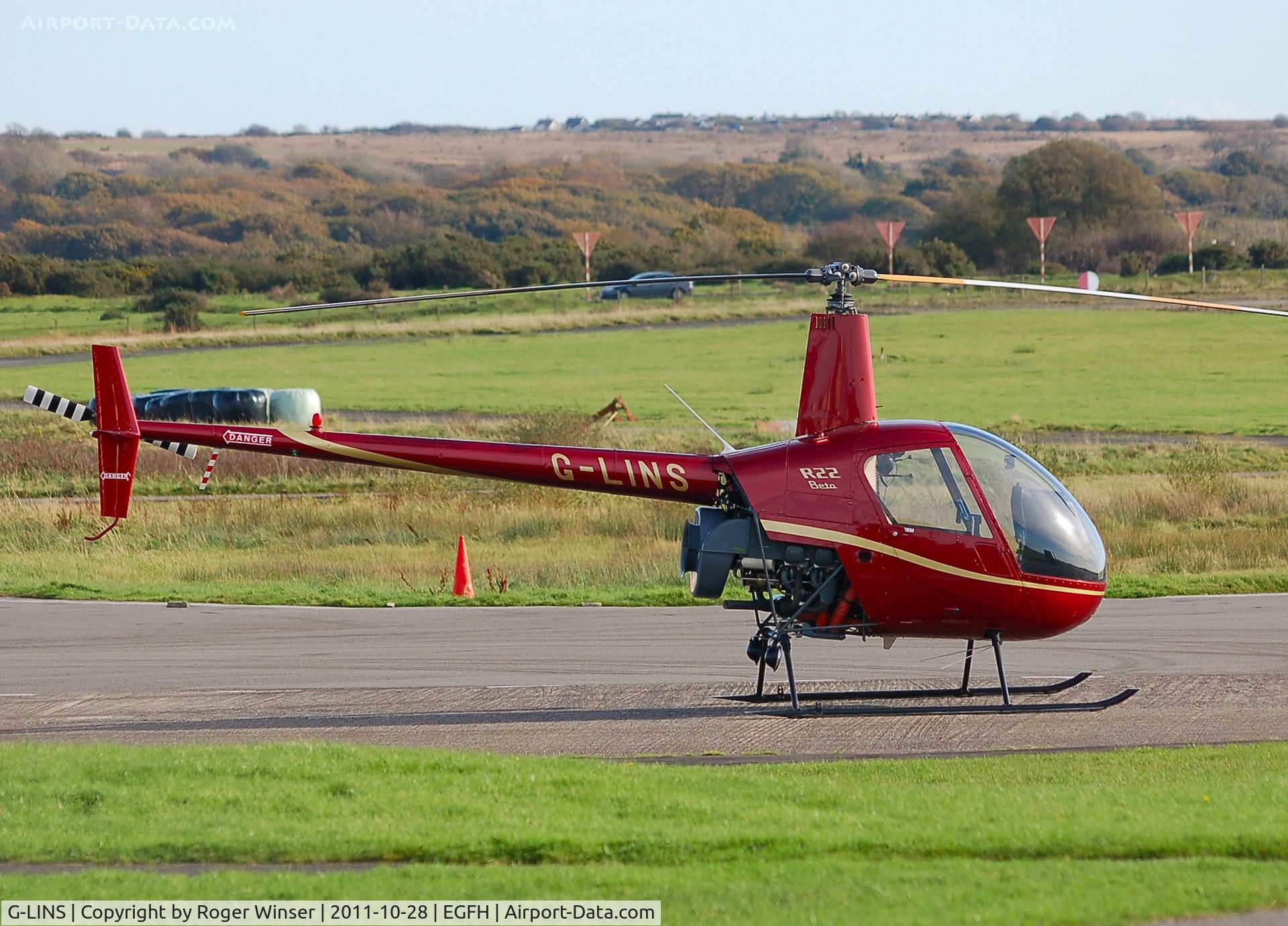 G-LINS, 1989 Robinson R22 Beta C/N 1201, On the apron. Operated by Heli-air Wales.