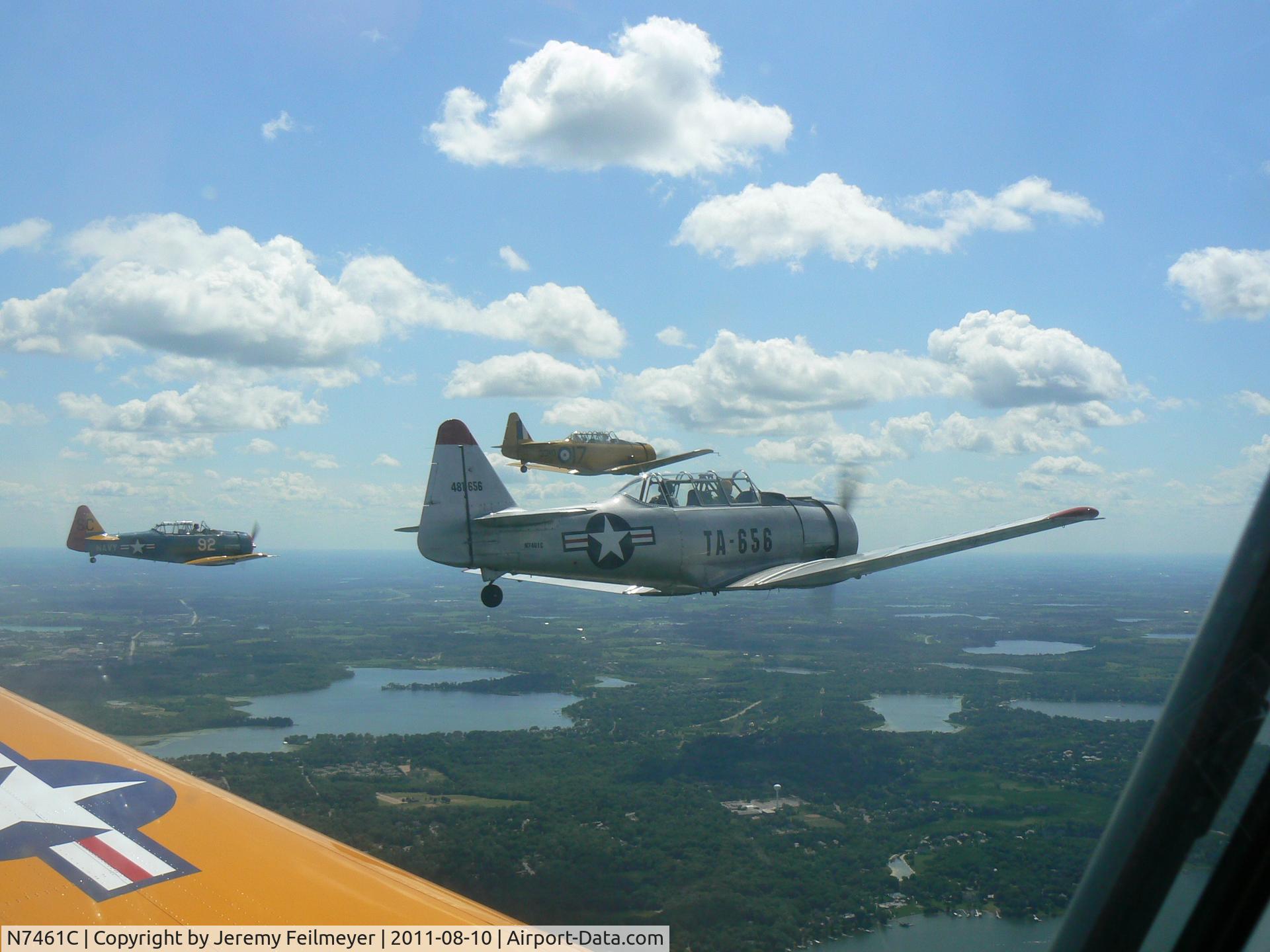N7461C, 1944 North American AT-6F C/N 121-42378, Taken over Lake Minnetonka, three airplanes, including N7461C and NX02019 unable to find picture with tail number of blue airplane.