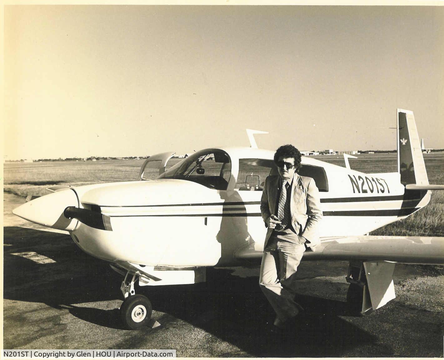 N201ST, 1977 Mooney M20J 201 C/N 24-0201, Pilot:  Charlie Blair, Mooney Structures Engineer

I had just flown this airplane to Houston with Glen, the company photographer.  He took the photo as we were preparing to return to Kerrville.