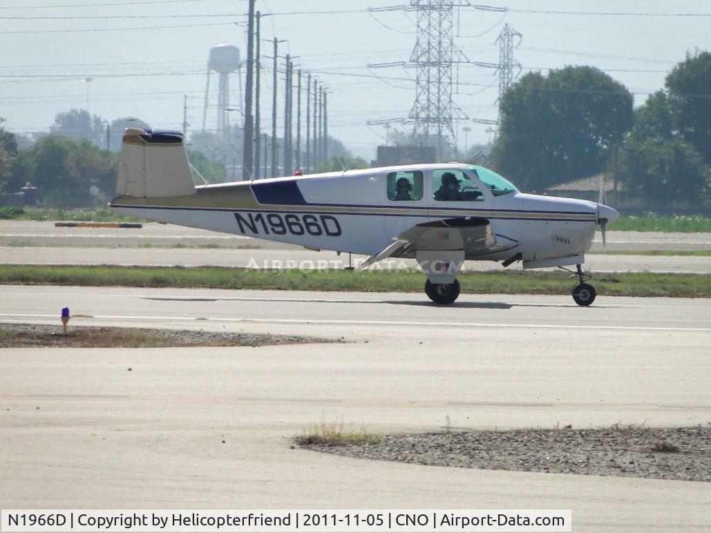 N1966D, 1952 Beech C35 Bonanza C/N D-3249, Rolling out after landing on runway 26R, passenger in the rear watching photographer