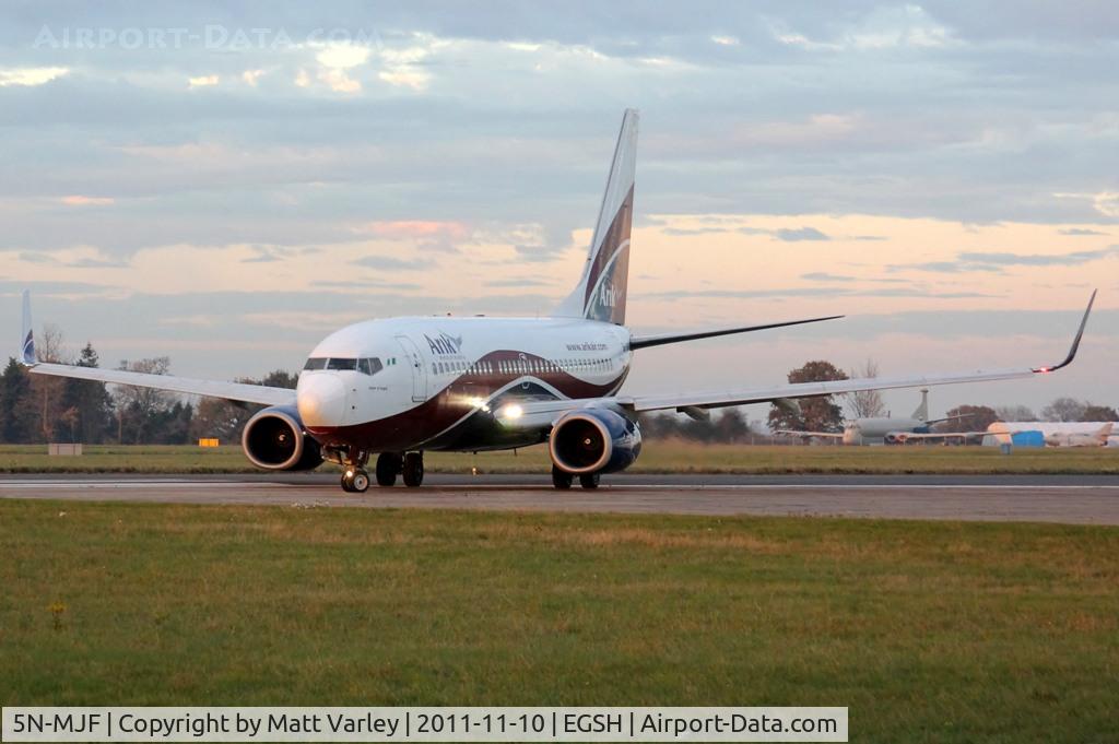 5N-MJF, Boeing 737-7GL C/N 34762/2427, Departing EGSH in the low evening sun.