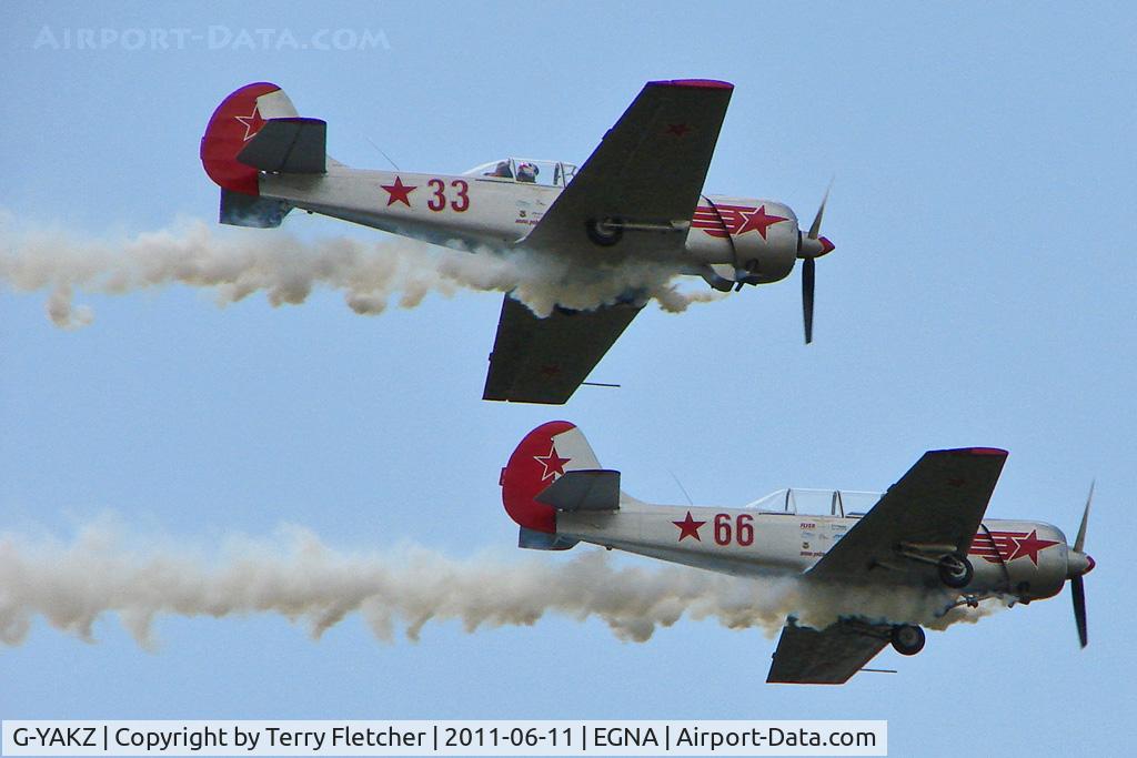 G-YAKZ, 1985 Yakovlev Yak-50 C/N 853206, Two of the four Yak Display team arriving  at the 2011 Merlin Pageant held at Hucknall Airfield