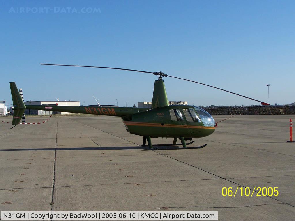 N31GM, 2001 Robinson R44 C/N 1117, Sitting on the tarmac at KMCC.  Formerly with the ponzi scheme flight school, Silver State Helicopters.