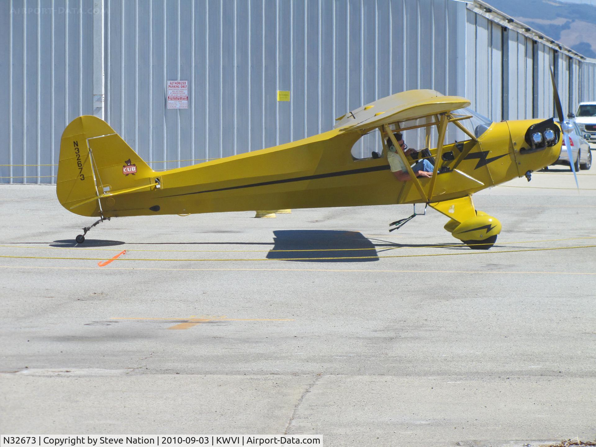 N32673, 1940 Piper J3C-65S Cub C/N 5532, 1940 Piper J3C-65S Cub taxying by hangars @ Watsonville Fly-In