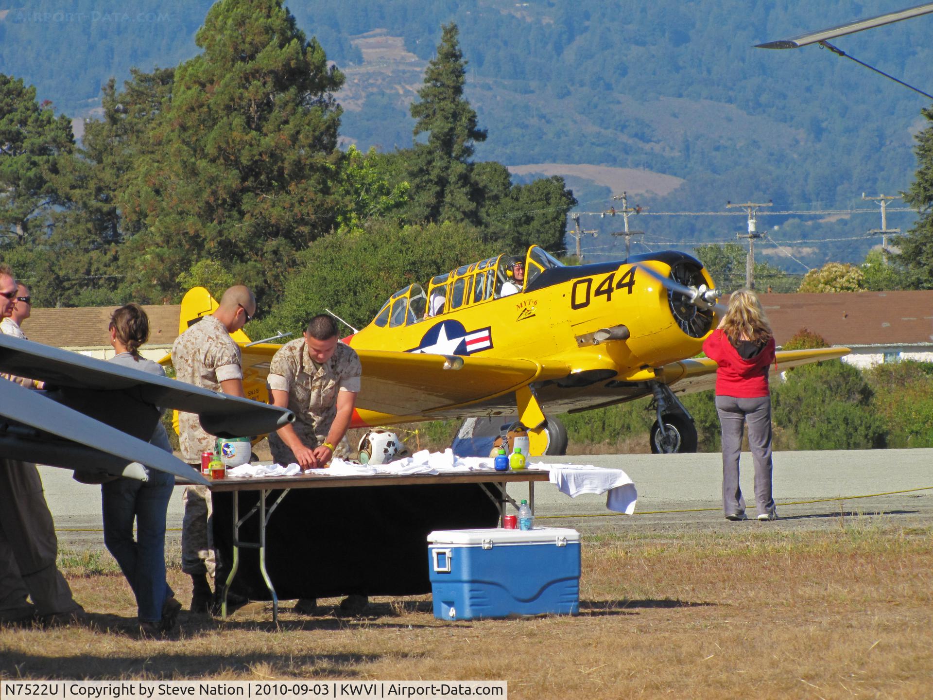 N7522U, 1952 Canadian Car & Foundry Harvard MK IV C/N CCF4-214, 2010 Watsonville Fly-In: USAF Reserve C-17A crew setting up table ewith Harvard Mark IV N7522U in background