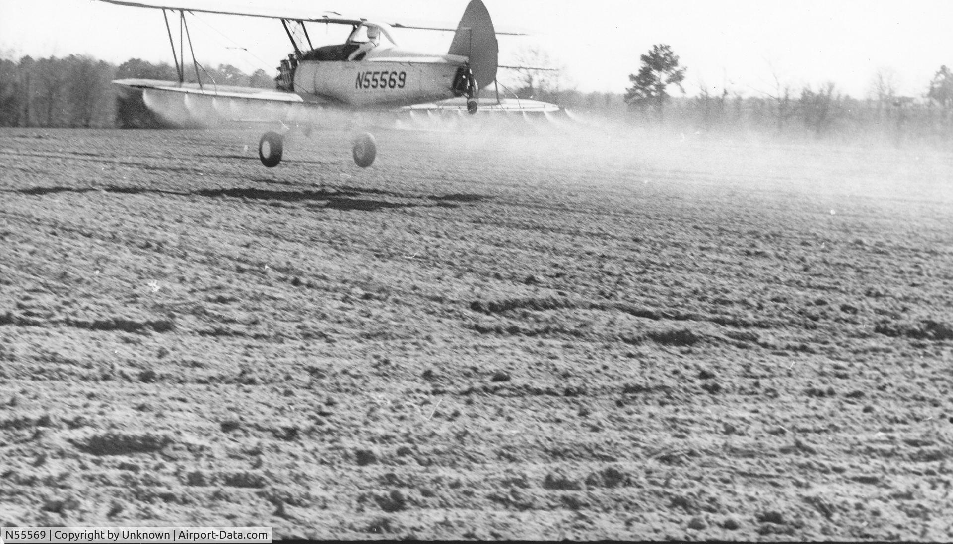 N55569, 1941 Boeing A75N1(PT17) C/N 75-1875, Crop spraying in Brooks County GA. circa 1971. Pilot is John Kristl. 240 gal tank takes up front seat. No room for instrument panel so they were on the struts.