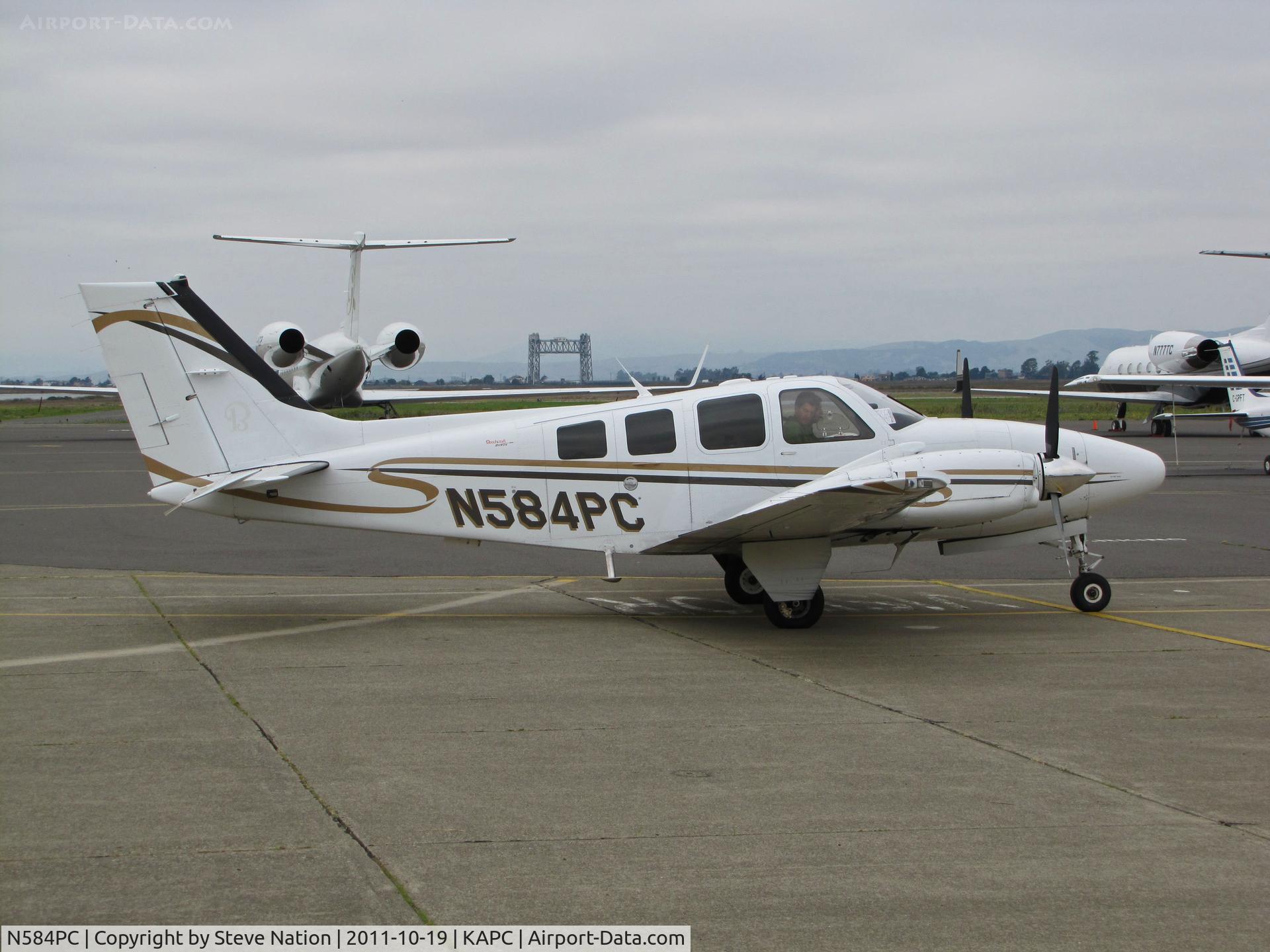 N584PC, 2007 Hawker Beechcraft Corp G58 Baron C/N TH-2211, Paramount Citrus Assoc (Dinuba, CA) 2007 Hawker Beechcraft 2007 G58 Baron departing Napa, CA  with Napa River RR Bridge in background