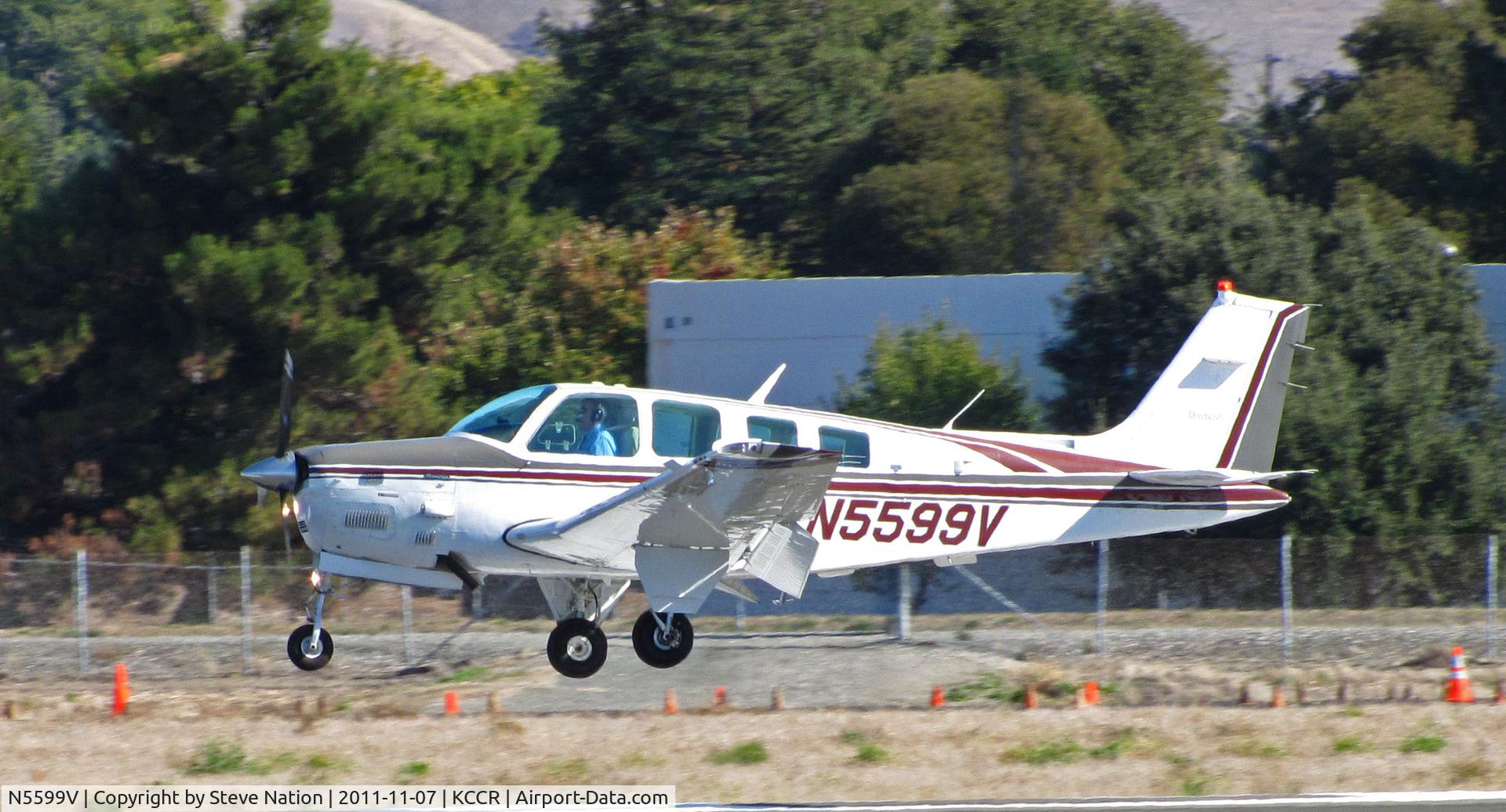 N5599V, 1989 Beech B36TC Bonanza C/N EA-500, 1989 Beech B36TC landing on RWY 32R at Buchanan Field (door was ajar)