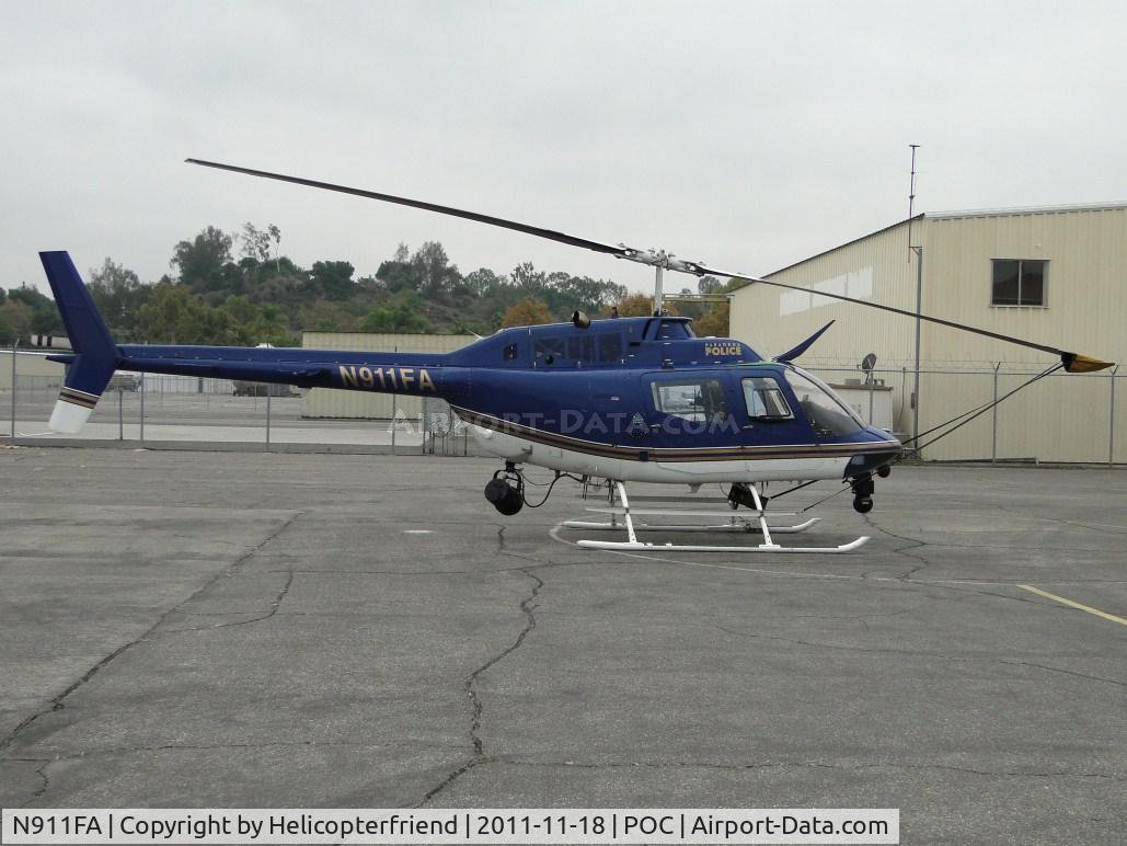 N911FA, Bell OH-58A Kiowa C/N 70-15152, Parked in Pomona PD hanger's fenced helipad
