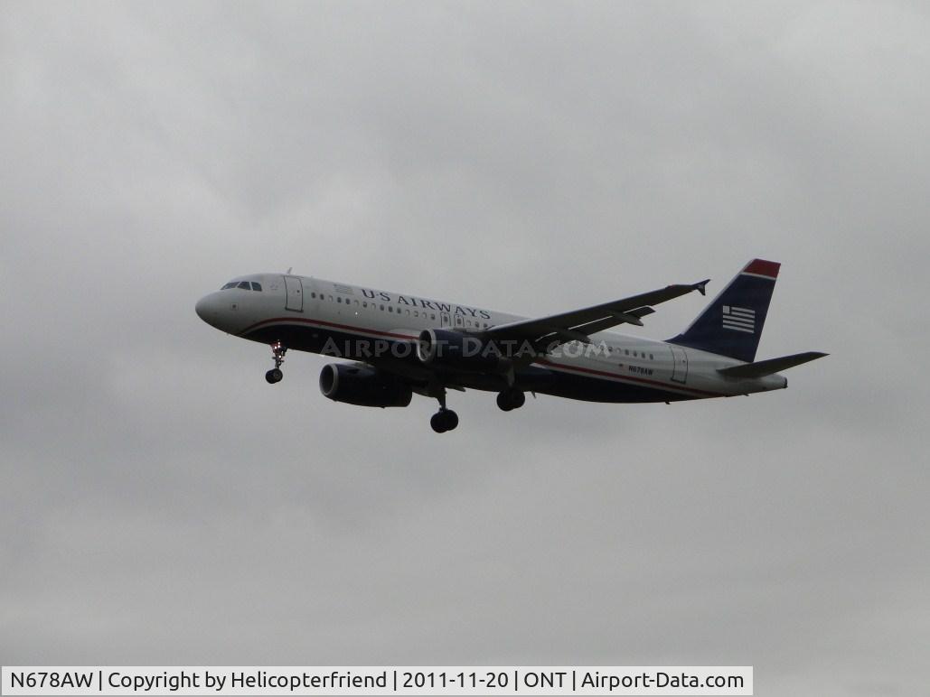 N678AW, 2005 Airbus A320-232 C/N 2482, On final to runway 26L in overcast weather