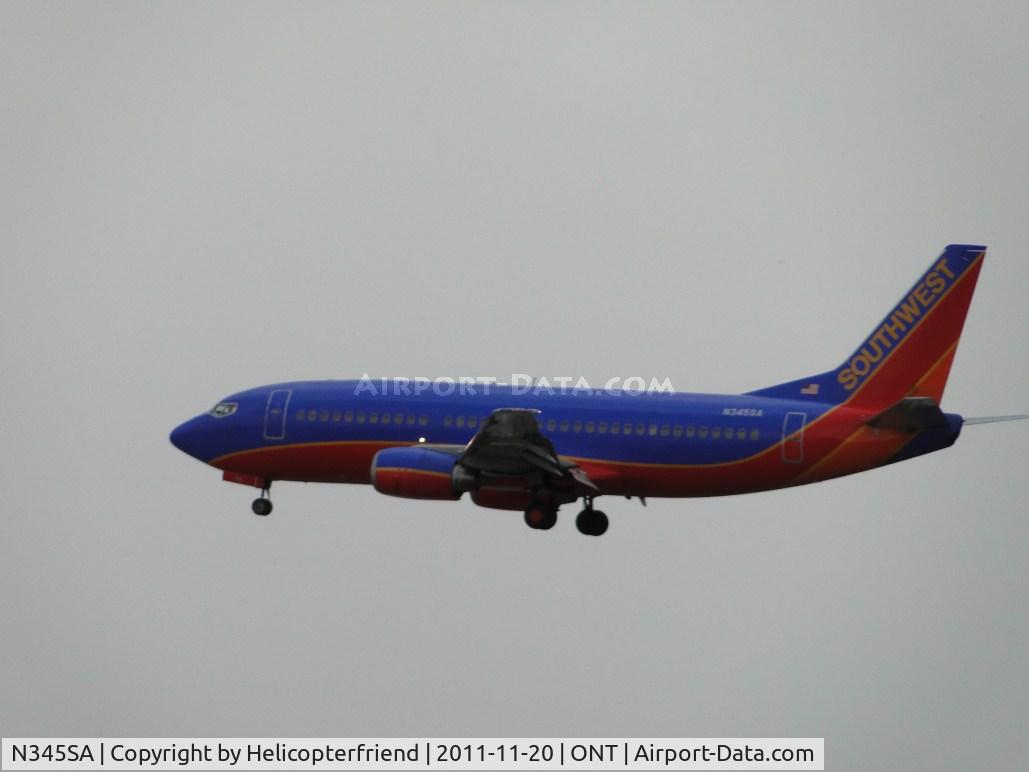 N345SA, 1987 Boeing 737-3K2 C/N 23786, On final for runway 26L under overcast skies