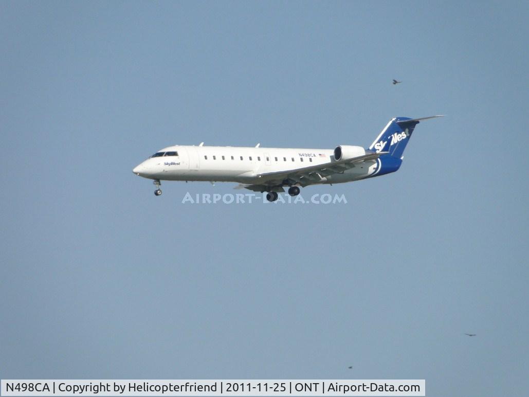 N498CA, 2003 Bombardier CRJ-200ER (CL-600-2B19) C/N 7792, Sky West on final to runway 26R with three guest flying in the area also