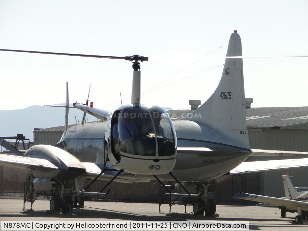 N878MC, 2005 Robinson R22 Beta C/N 3782, Air taxiing to paint shop area, just came around the corner between the hangers