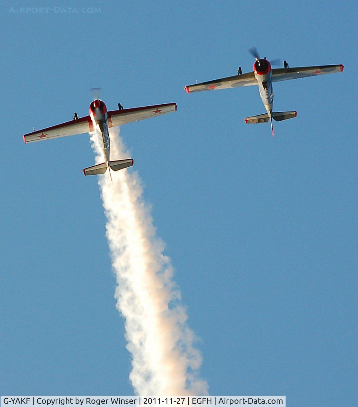 G-YAKF, 1991 Yakovlev (Aerostar) Yak-52 C/N 9111205, With smoke on. In formation aerobatic practice with G-BVVA.