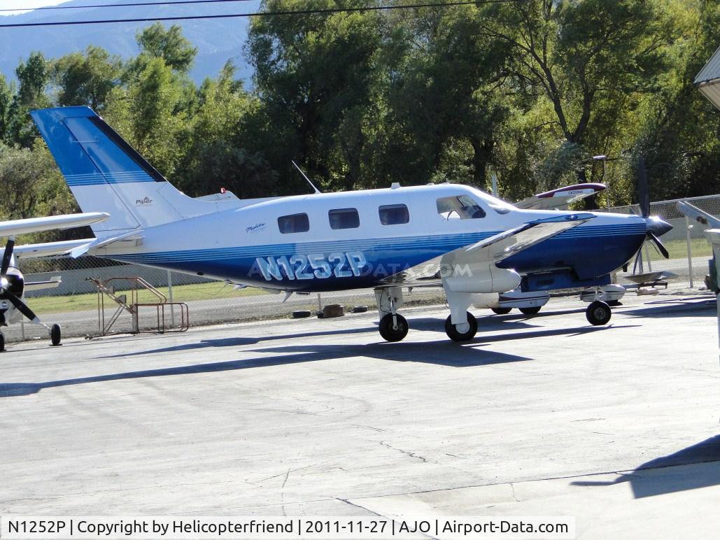 N1252P, 1999 Piper PA-46-350P Malibu Mirage C/N 4636213, Parked by a hanger