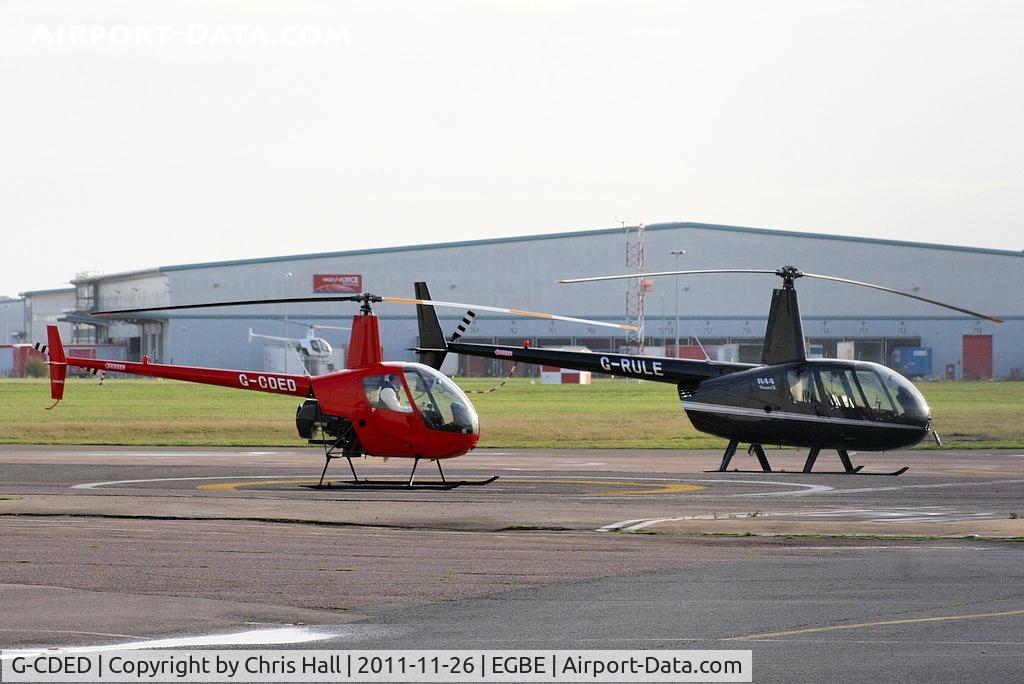 G-CDED, 2004 Robinson R22 Beta C/N 3747, with G-RULE and G-HONI flying in the background