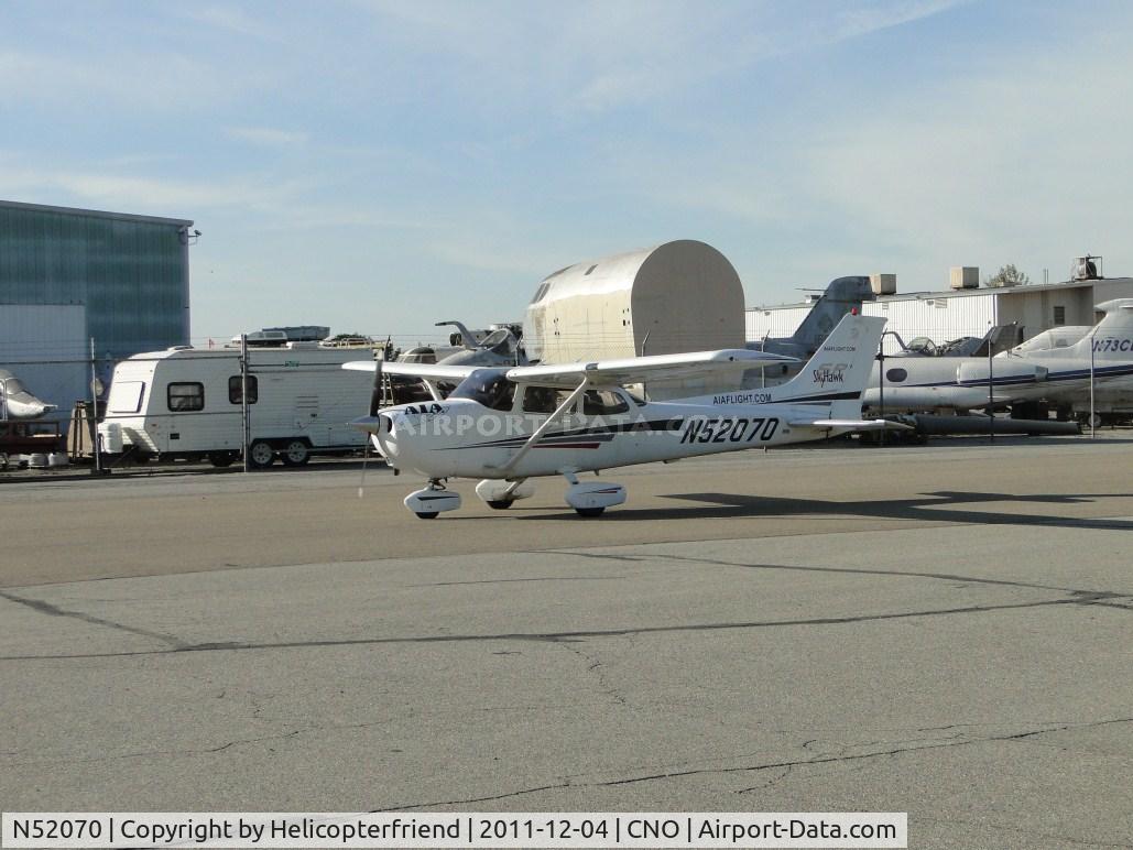 N52070, 2002 Cessna 172S C/N 172S9077, Taxiing southbound, east of Yank's Air Museum, towards the runways