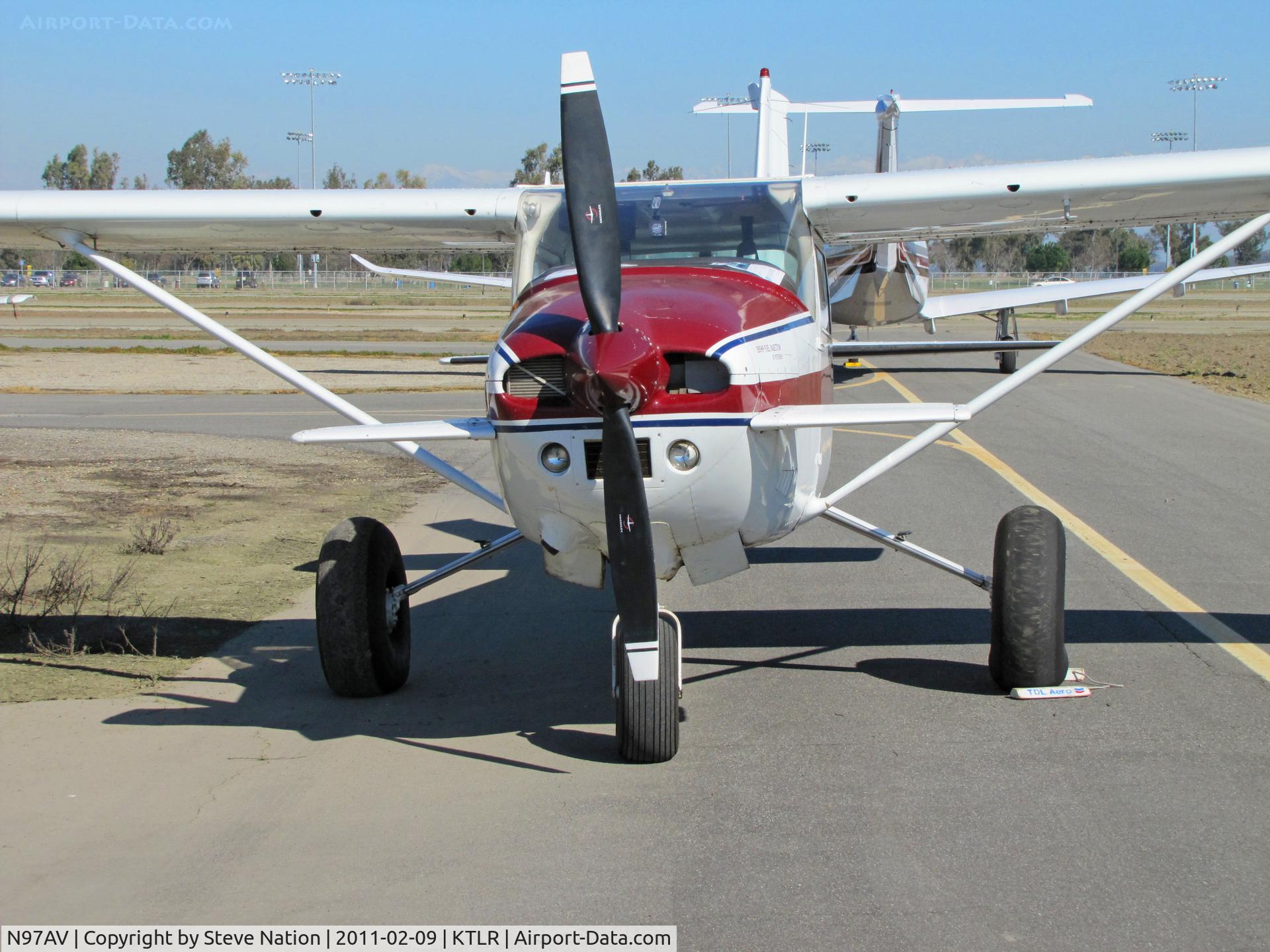 N97AV, 1979 Cessna 182Q Skylane C/N 18266809, Head on shot of highly modified 1979 Cessna 182Q with bush operations big wheels and canards on forward fuselage (parked on sloping taxiway!) @ Tulare, CA