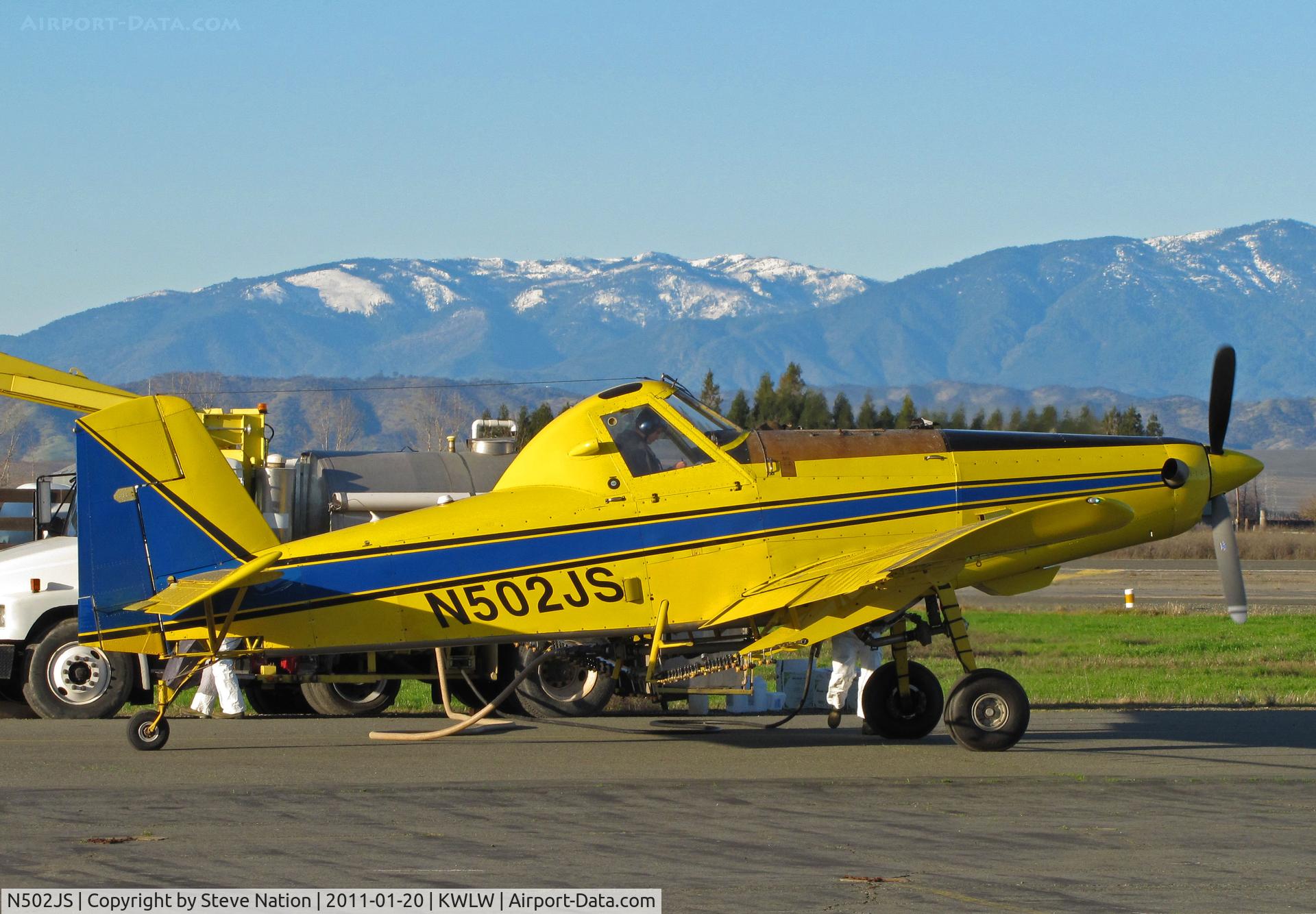 N502JS, 1994 Air Tractor Inc AT-502B C/N 502B-0248, Reg Michaud Aviation (Willows, CA) 1994 AT-502B rigged for spraying and framed by snow covered Coastal Range peaks while taking on load @ Willows, CA
