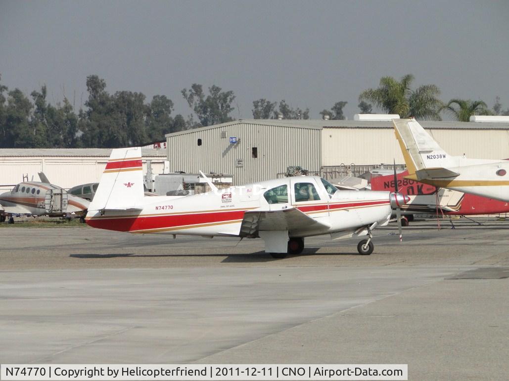N74770, 1961 Mooney M20B Mark 21 C/N 1770, Preflighting prior to taxiing to runway 26