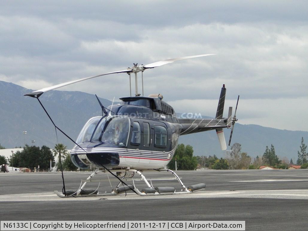 N6133C, 1991 Bell 206L-3 LongRanger III C/N 51544, Tied down and parked north of a hanger on the helipad at the east side