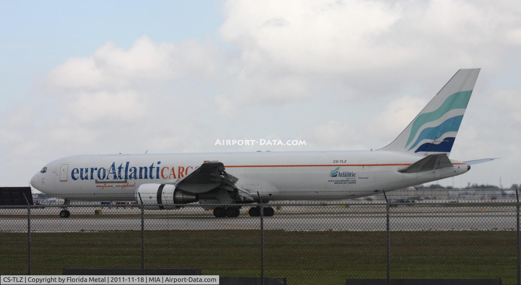 CS-TLZ, 1988 Boeing 767-375 C/N 24086, Clouds darken by picture of a Euro Atlantic 767.  94th Aero Squadron is a good place to get shots if you can get above that fence.  I was standing on the back of my car and still get the fence in the undercarriage.  If I still had my Dodge Ram 4x4, could 