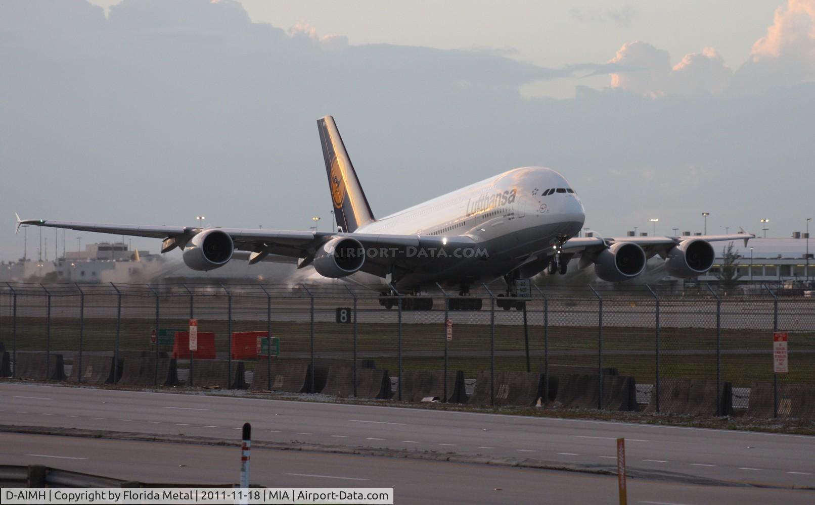 D-AIMH, 2010 Airbus A380-841 C/N 070, Lufthansa A380 taking off at dusk.  I went down to 94th Aero Squadron to get this.  I am standing on the back of my car as a cop on Perimeter Rd is signaling for me to get down.