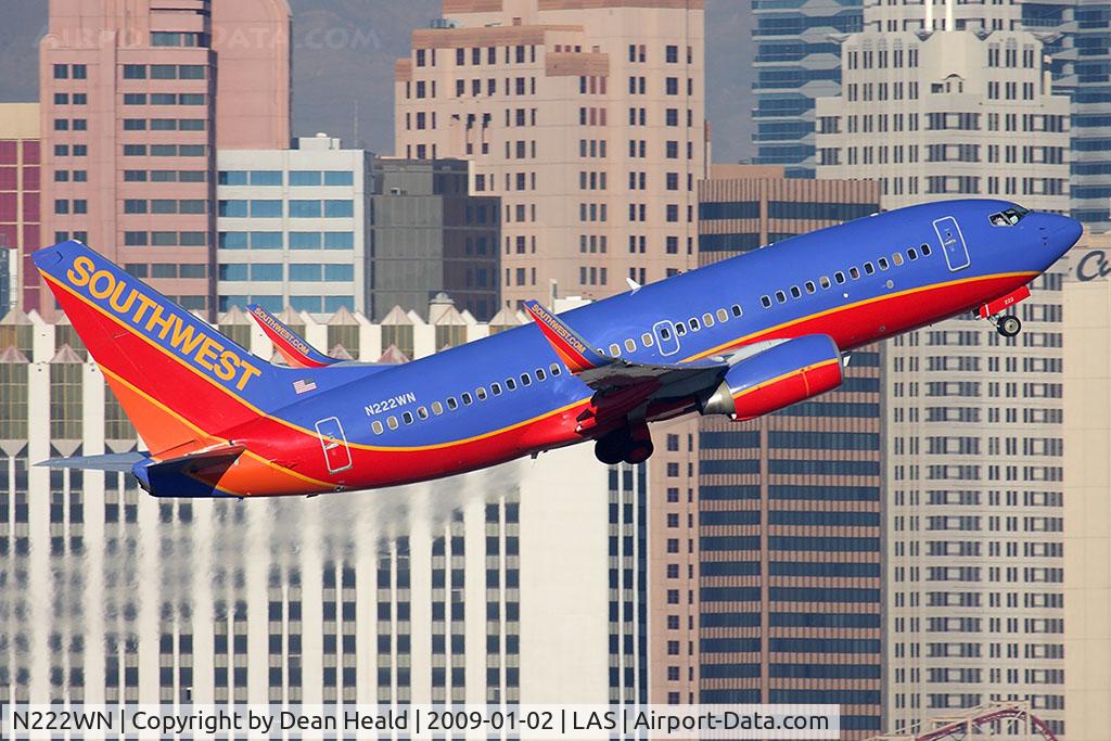 N222WN, 2005 Boeing 737-7H4 C/N 34290, Southwest Airlines N222WN (FLT SWA297) climbing out from RWY 1R, with a nice backdrop of the NY, NY Hotel and Casino, en route to Phoenix Sky Harbor Int'l (KPHX).