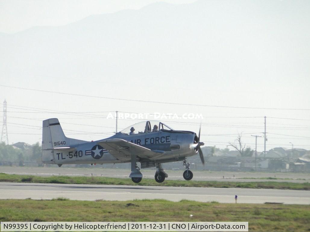 N99395, 1945 North American T-28A Trojan C/N 49-1540A, Landing on runway 26R and back seater checking out photographer