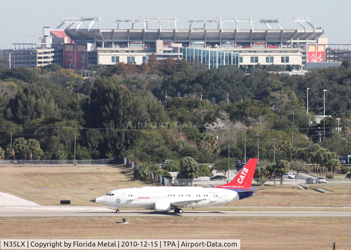 N35LX, 1986 Boeing 737-330 C/N 23528, Catbird taxiing out for a test flight after work being done on it - Raymond James Stadium, home of the Tampa Bay Bucaneers in background