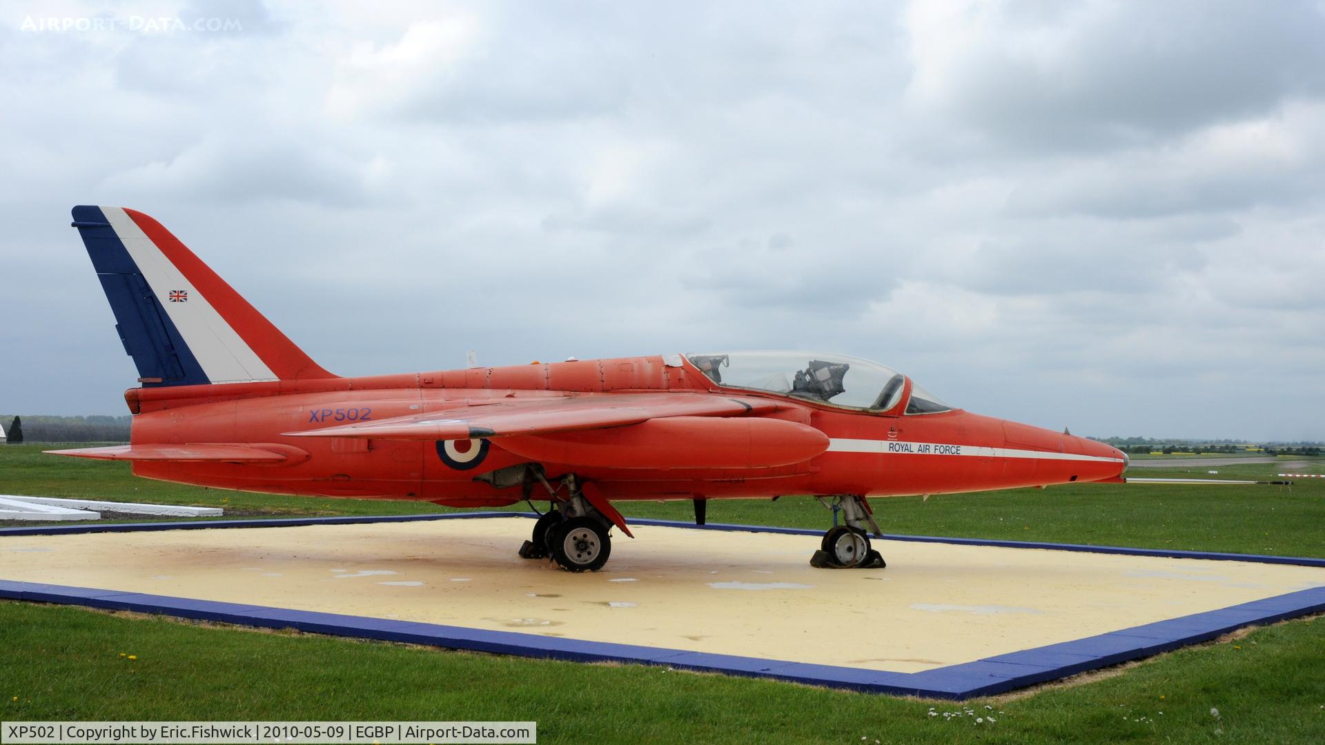 XP502, 1962 Folland Gnat T.1 C/N FL517, XP502 / 02 (cn FL517) The Gnat is preserved in front of the control tower in Red Arrows colours to commemorate the fact that Kemble was the base for the Red Arrows during the fifteen years the team operated the type.