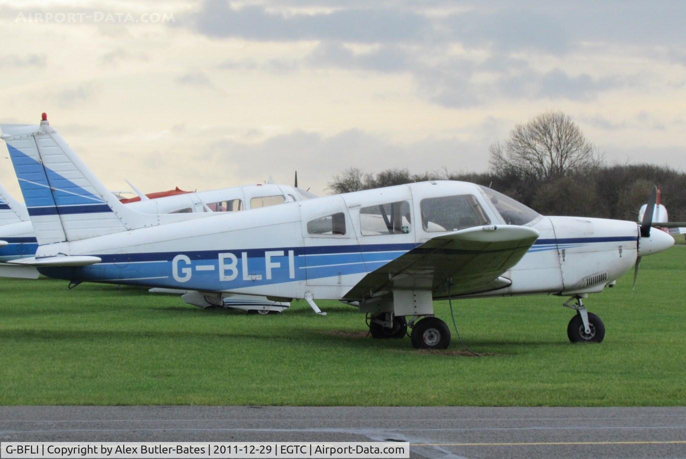 G-BFLI, 1977 Piper PA-28R-201T Cherokee Arrow III C/N 28R-7803134, Parked on the grass