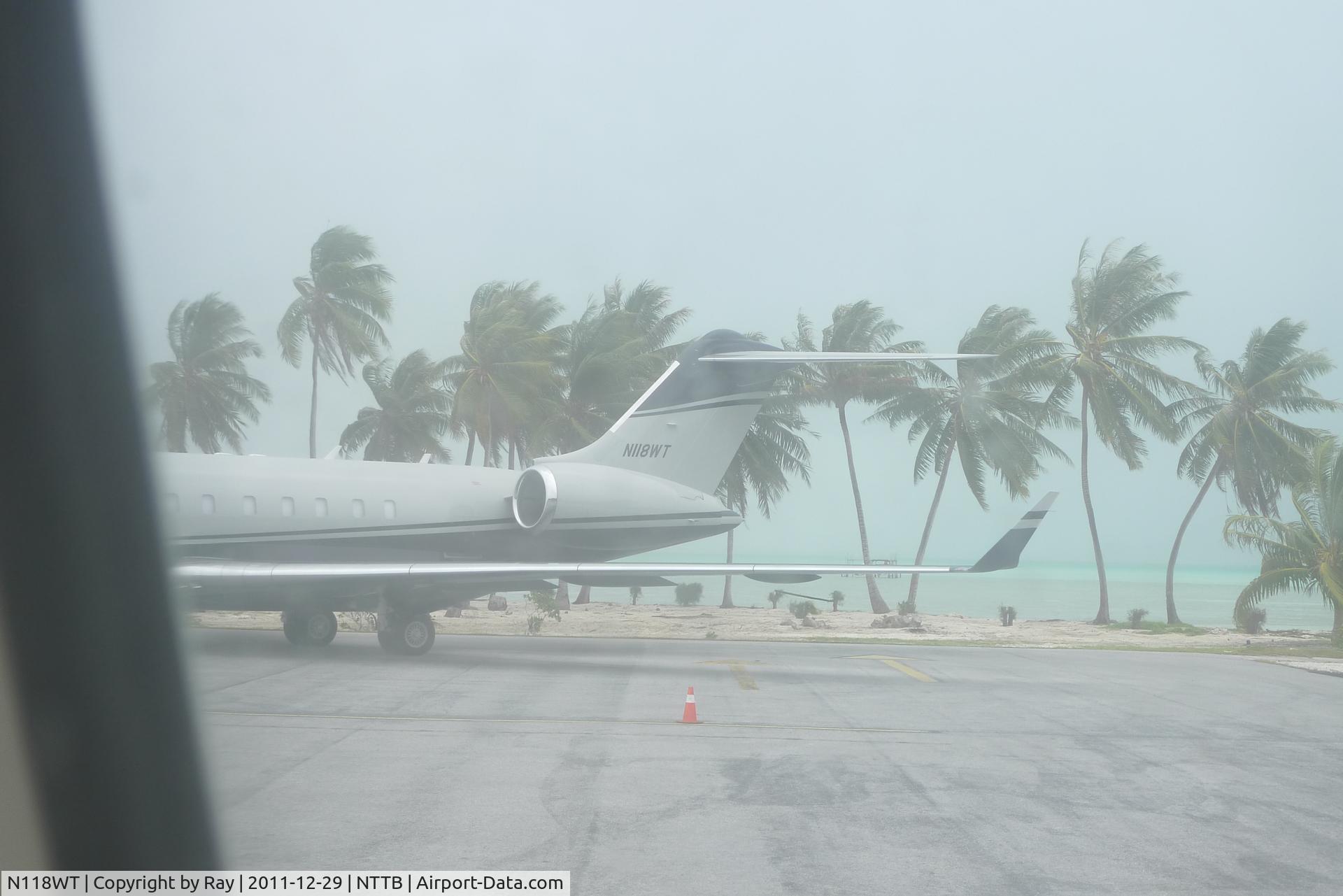N118WT, Bombardier BD-700-1A10 Global Express C/N 9327, parked at the Bora Bora airport, during a bit of rain.